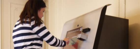 a student uses the ipad kiosk